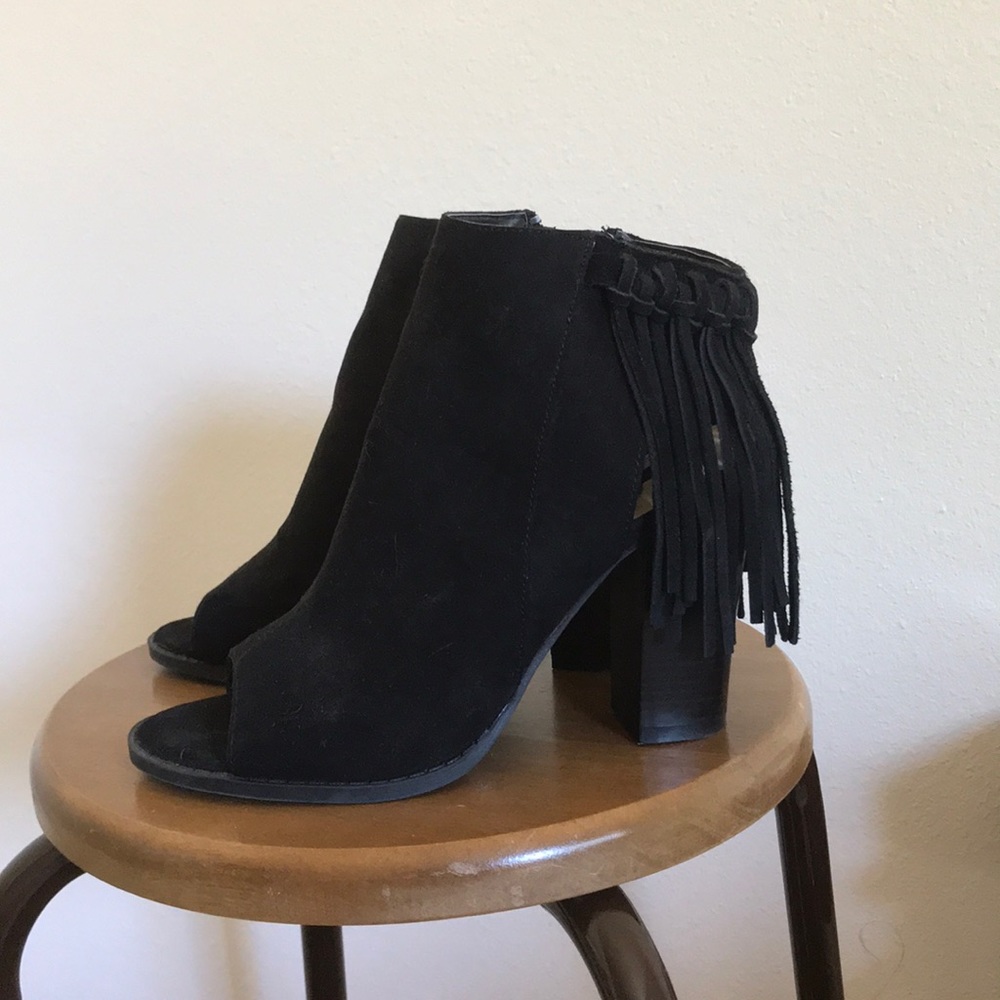 Black booties with fringe around the ankles